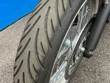 a close up of a motorcycle parked in front of a blue wall