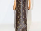 a close up of a louis vuitton bag on a white surface