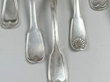 several silver spoons and spoon spoons are arranged on a table