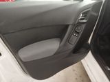 the interior of a car with the door open and the driver ' s seat down