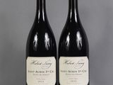 two bottles of wine sitting next to each other on a table