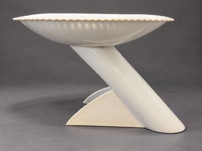 an image of a white bowl on a stand on a gray background