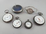 several different types of pocket watches sitting on top of a table