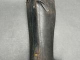 someone is holding a leather case that has a small hole in it