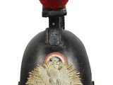 an old black helmet with a red feather on top of it