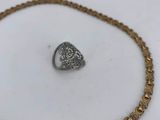a close up of a necklace and a ring on a table