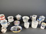 many different types of cups and saucers on the table