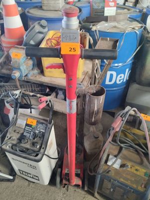 a red fire hydrant sitting next to a pile of junk