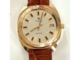 une photo d'une montre en or avec un bracelet marron