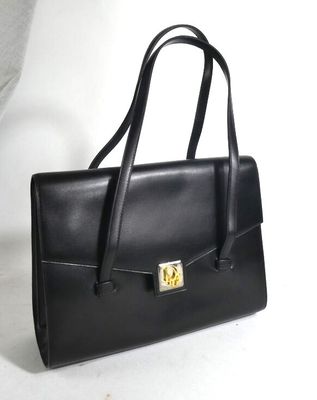 black leather handbag with a gold lock on the front
