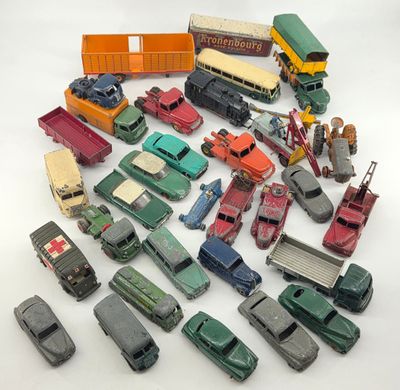 a lot of toy cars and trucks on a white surface