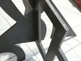 a close up of a metal bench on a tiled floor