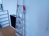 a ladder that is leaning against a wall in a room