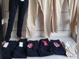 a woman standing on a shelf in a clothing store