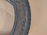 tires are stacked on top of a cardboard box on the floor