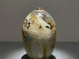 a vase that is sitting on a table with a light on it
