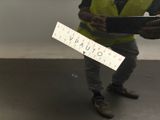 a man that is holding a sign in his hand