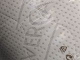 a close up of a mattress that has a small logo on it