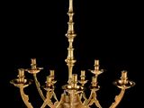 a brass chandelier with five arms and five candles