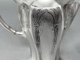 a silver tea pot that is sitting on a table