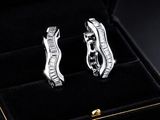 pair of diamond earrings in a black box on a black background