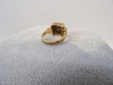 a close up of a gold ring with a stone in it
