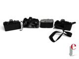 three cameras sitting next to each other on a white surface