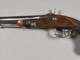 a close up of a gun on a table with a white background
