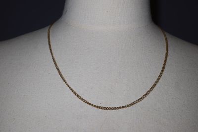 a close up of a mannequin torso with a chain on it