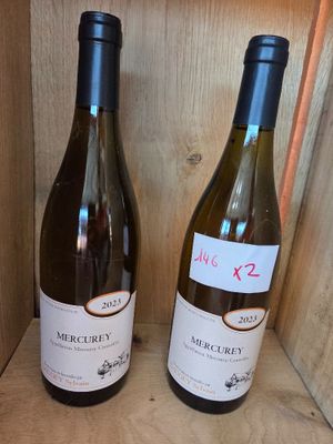 two bottles of wine that are sitting on a shelf