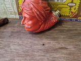 a small statue of a man with a cigar in front of a box of cigars