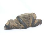 an old figurine of a dog laying down on its side