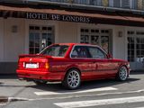 a red car that is parked in front of a hotel