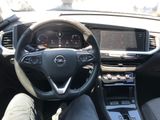 the interior of a car with a steering wheel and dashboard controls
