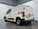 a white van with red stripes parked in a garage