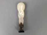 an image of a white and black sculpture on a gray surface
