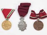 three medals and a medal on a white surface