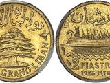 a close up of a gold coin with a tree on it