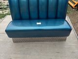 a blue couch that is sitting in the back of a truck