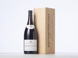 a bottle of wine sitting next to a wooden box