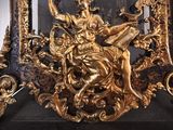 a gold statue of a woman sitting on top of a table