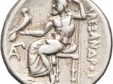 a close up of a silver coin with a woman sitting on a chair