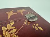 a small wooden box with a bird design on it