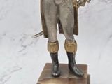 a statue of a man in a military uniform holding a sword