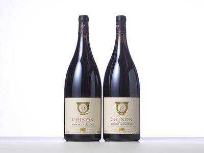 two bottles of wine sitting on top of a table