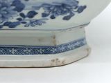 a blue and white bowl sitting on a white surface