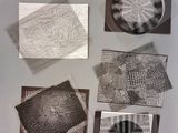 several pieces of art are displayed on a table