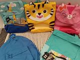 several backpacks are lined up on a bed in a room