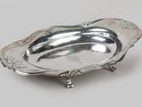 a silver plate with a decorative design on it