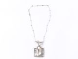 silver necklace with a square shaped pendant and a beaded chain on a white background